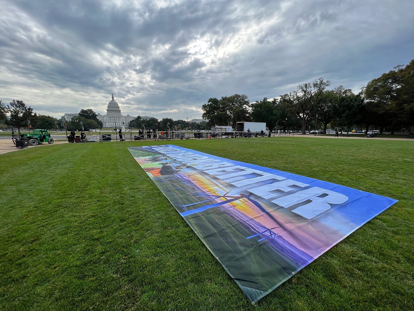 Climate Power banner lying flat on the lawn across from the Capitol building in DC